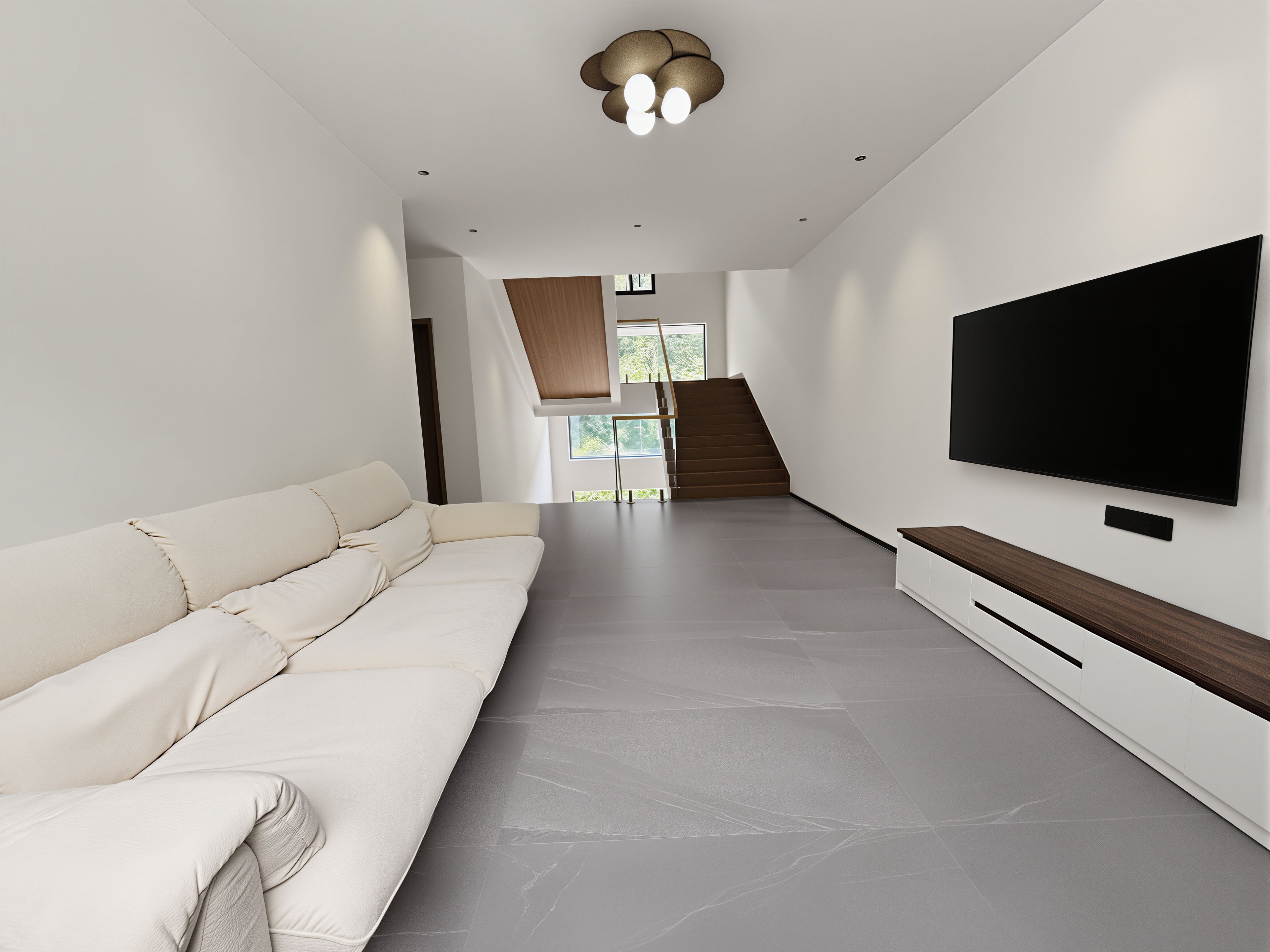 A modern living room with a sofa, a flat-screen TV, and a staircase leading to another level.