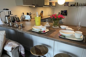 A kitchen counter with a coffee maker, toaster, and a yellow bottle. - Holiday apartment in Damp with swimming pool (Damp)