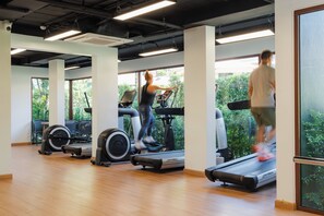 A gym with treadmills, stationary bikes, and rowing machines. - Brand-New Luxury Condo with Ultimate Convenience (Koh Samui)