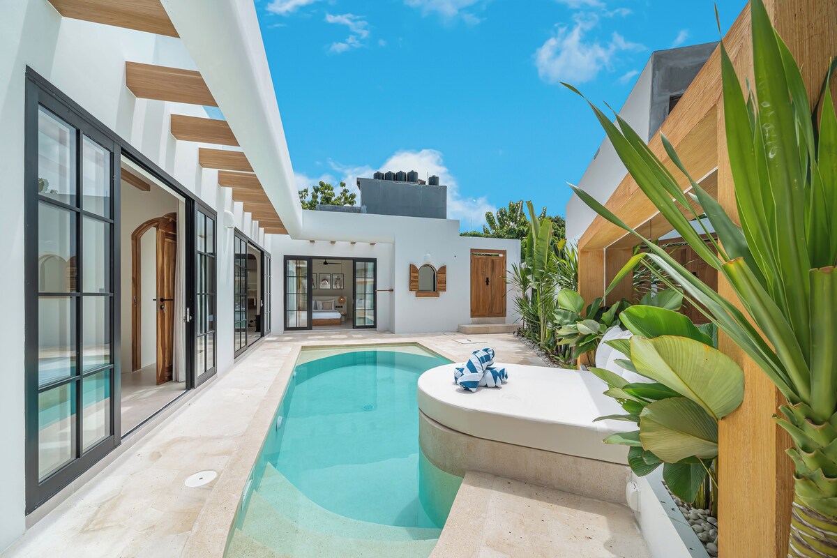 A modern house with a swimming pool, large glass doors, and a wooden exterior.