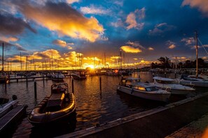 A marina with boats docked at the pier during sunset. - Holiday apartment in Damp with swimming pool (Damp)