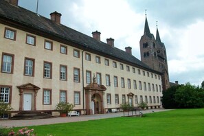 A large, historic building with a symmetrical facade, multiple windows, and a prominent tower with spires. - Holiday apartment with 2 bedrooms (Beverungen)