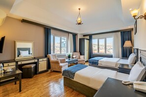 A hotel room with a bed, a desk, a chair, a table, and a view of the outdoors. - Ugurlu Termal Resort (Gaziantep)