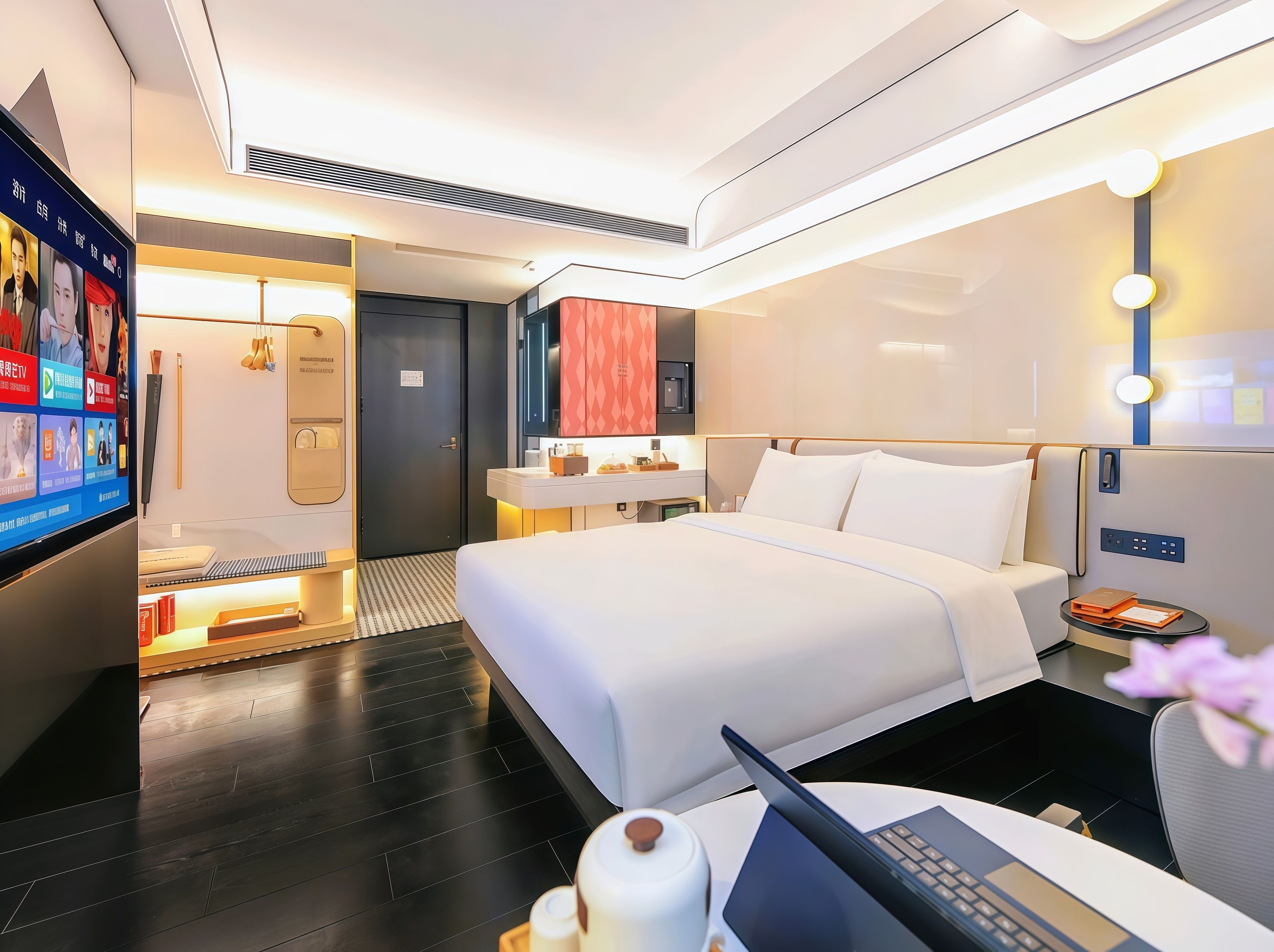 A modern hotel room with a bed, bedside table, lamp, and a TV displaying a menu.