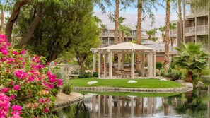 Un resort con piscina, un pabellón y palmeras.