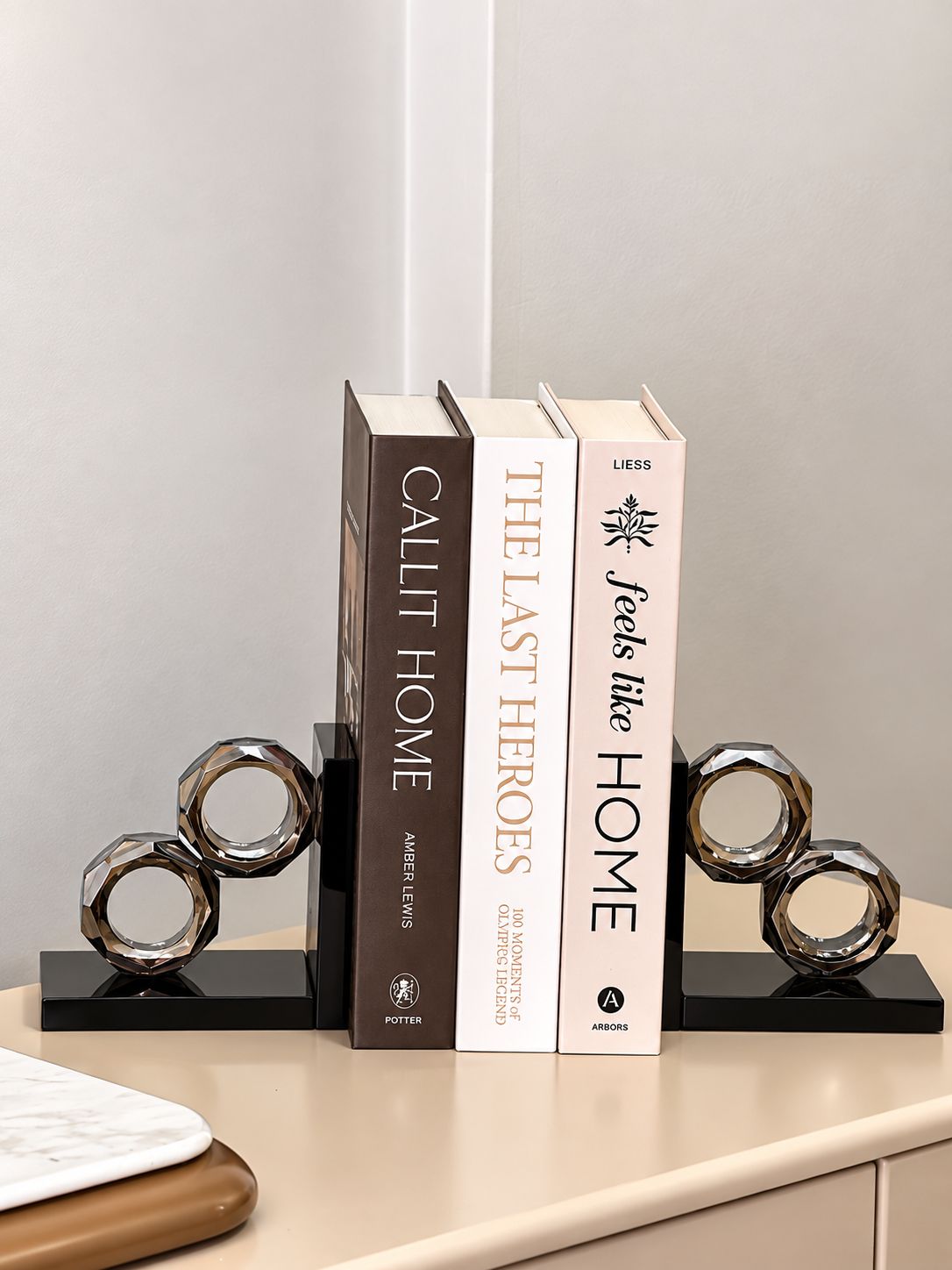 A bookshelf with three books titled 'Call It Home,' 'The Last Heroes,' and 'Feels Like Home.'