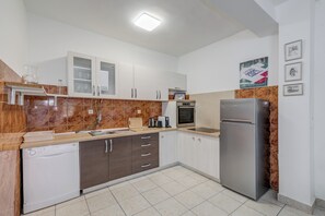 A modern kitchen with a dishwasher, oven, refrigerator, and a microwave. - Beachfront Sunshine apartment with garden in center (Split)