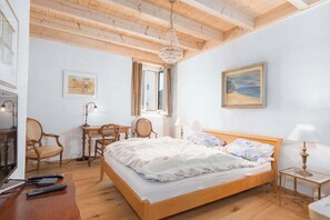 Spacious bedroom with a comfortable double bed and warm traditional Ticino character.
 - Charming house with patio near Lake Lugano (Magliaso)