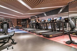 A gym with treadmills, exercise equipment, and a mirrored wall. - The G Shenzhen, A Tribute Portfolio Hotel (Shenzhen)