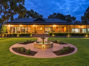 Exterior : Experience the magic of evenings at Bob’s River House, where glowing lights and landscaped gardens create a welcoming atmosphere.