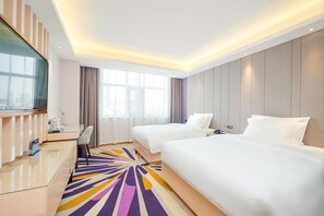 A hotel room with two beds, a desk with a chair, a television, and a large window with curtains. - Lavande Hotel (Beijing)