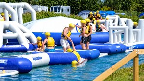 An inflatable water park with blue and white structures, including slides and platforms. - Grange Park 2-bed Caravan, Sleeps 6 With Parking (Mablethorpe)