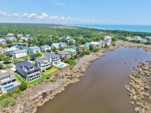 A coastal residential area with houses, a body of water, and a distant view of the ocean. - Eagles Nest | Gated Community, Beach, Golf & Ping Pong (Georgetown)