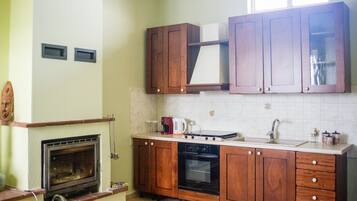 A kitchen with wooden cabinets, a stove, a dishwasher, and a tiled backsplash.