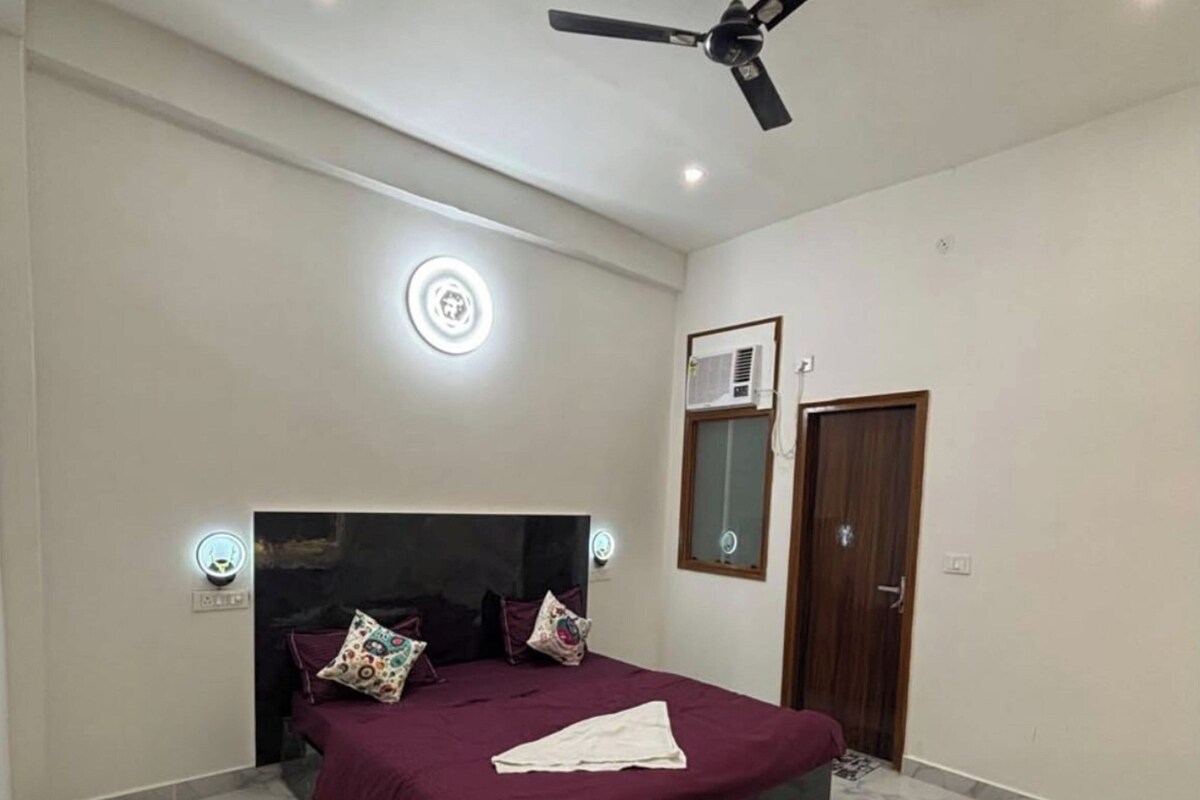 Un dormitorio con cama, ventilador de techo y aire acondicionado.