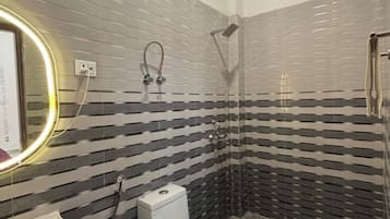 A bathroom with a toilet, sink, and shower.
