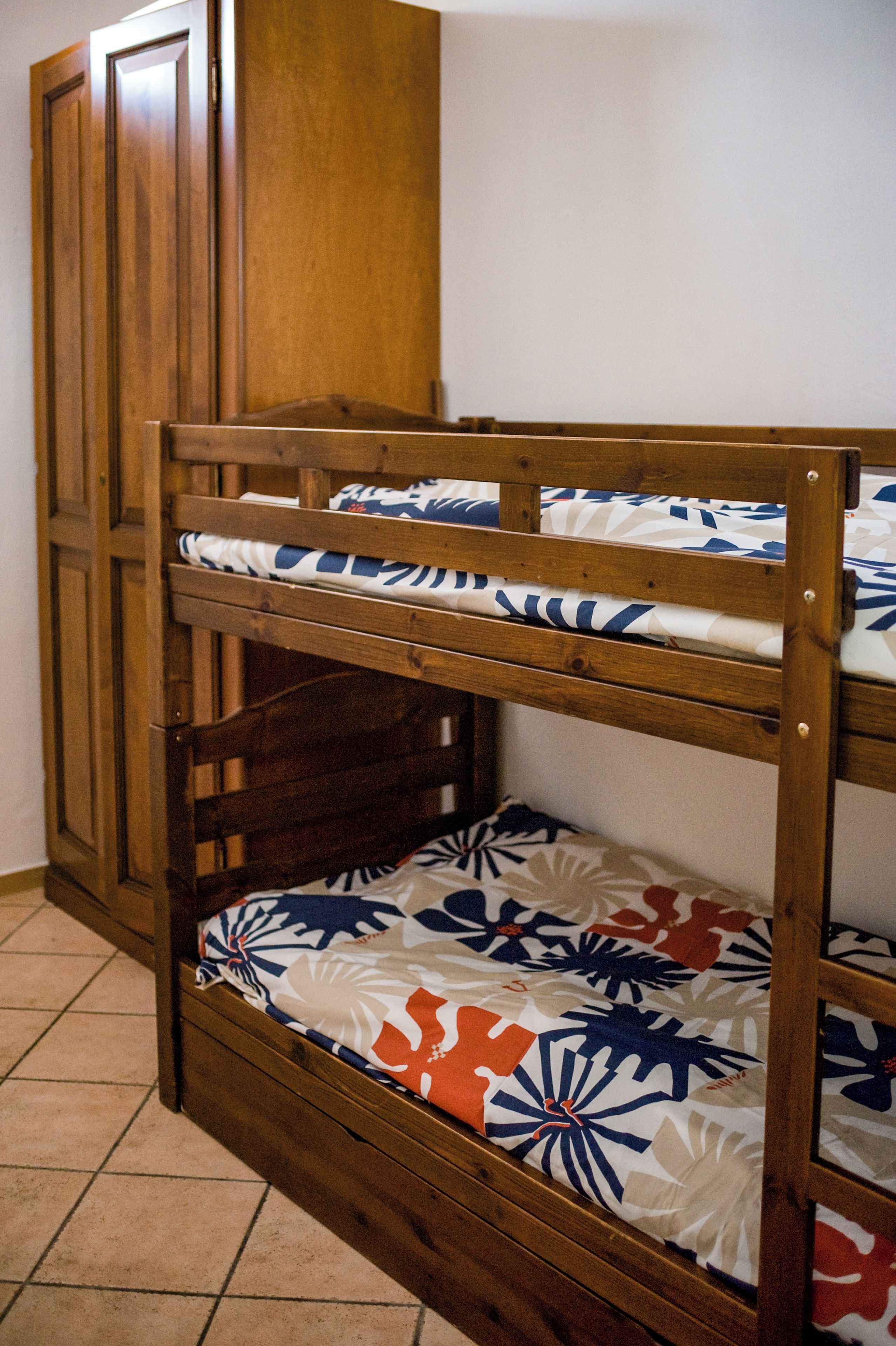 A bunk bed with a patterned mattress.