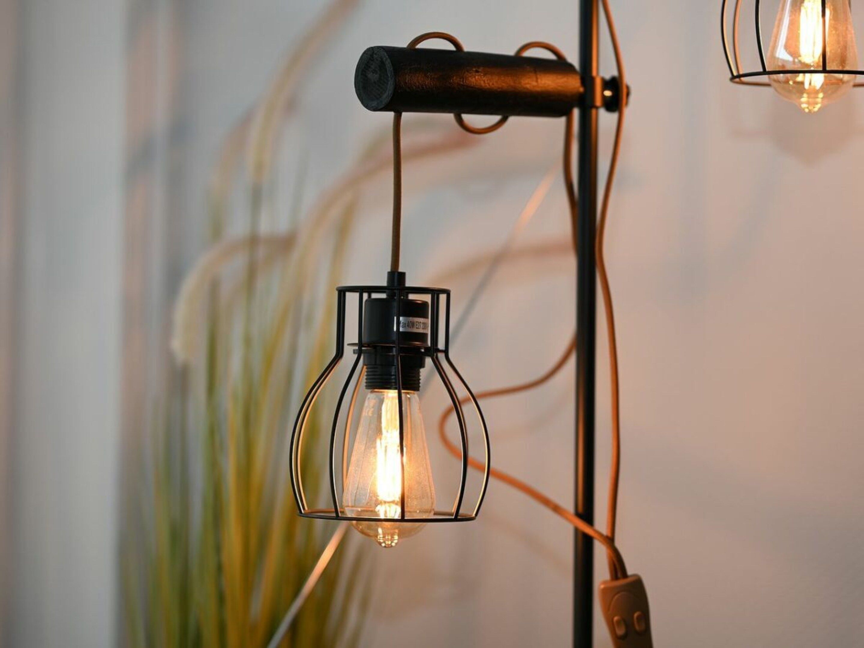 A pendant light fixture with a visible power cord and plug.