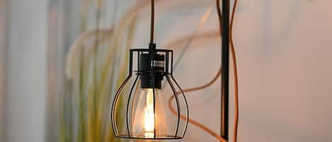 A pendant light fixture with a visible power cord and plug.