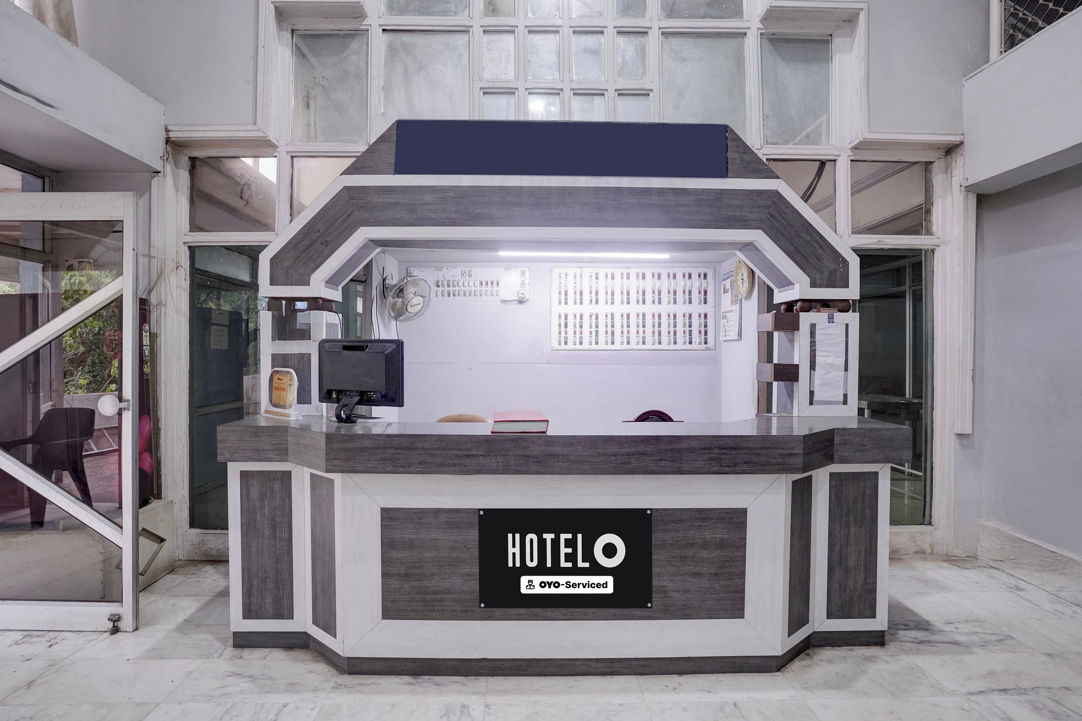 A hotel reception desk with a sign indicating it is serviced by YOYO.