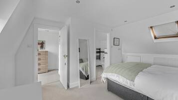 A bedroom with a bed, a radiator, and a window.