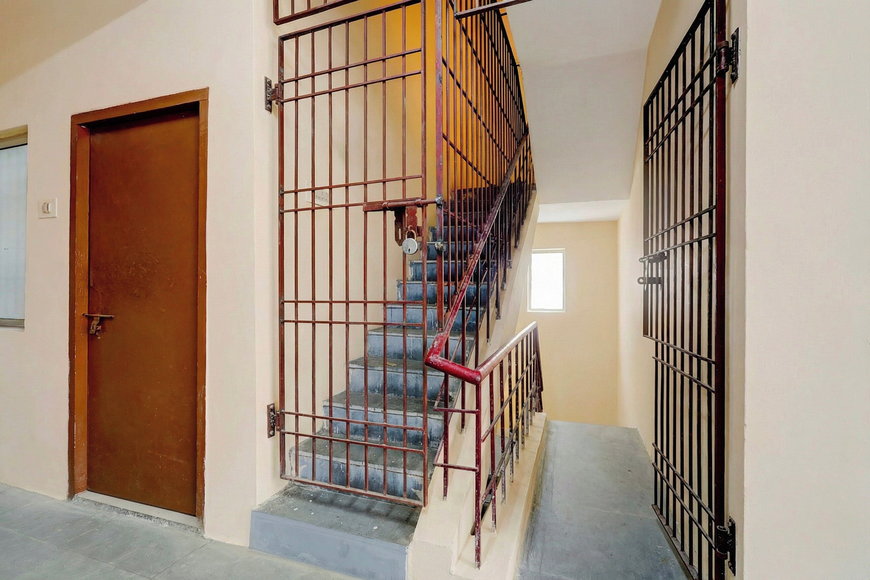 A staircase with metal railings and a door at the bottom.