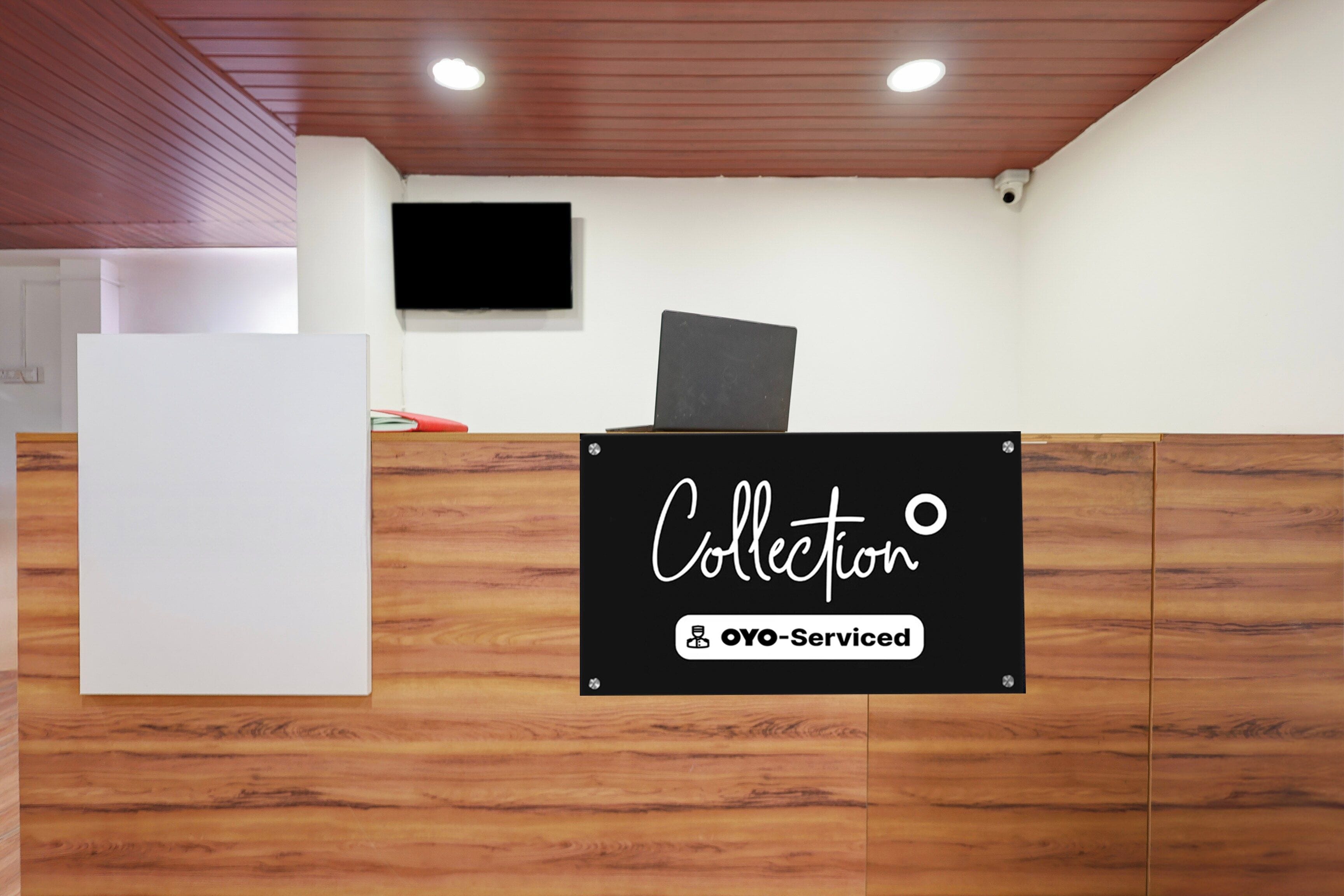 A reception desk with a sign that reads 'Collection' and 'OYO-Serviced'.