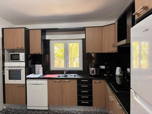 A compact kitchen with a built-in oven, microwave, and coffee maker. - Villa with heatable pool in Carvoeiro (Carvoeiro)