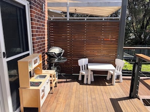 A patio with a grill, a small table, and two chairs. - A refined family retreat with al fresco living, a pool and swift transport links (Banksia)