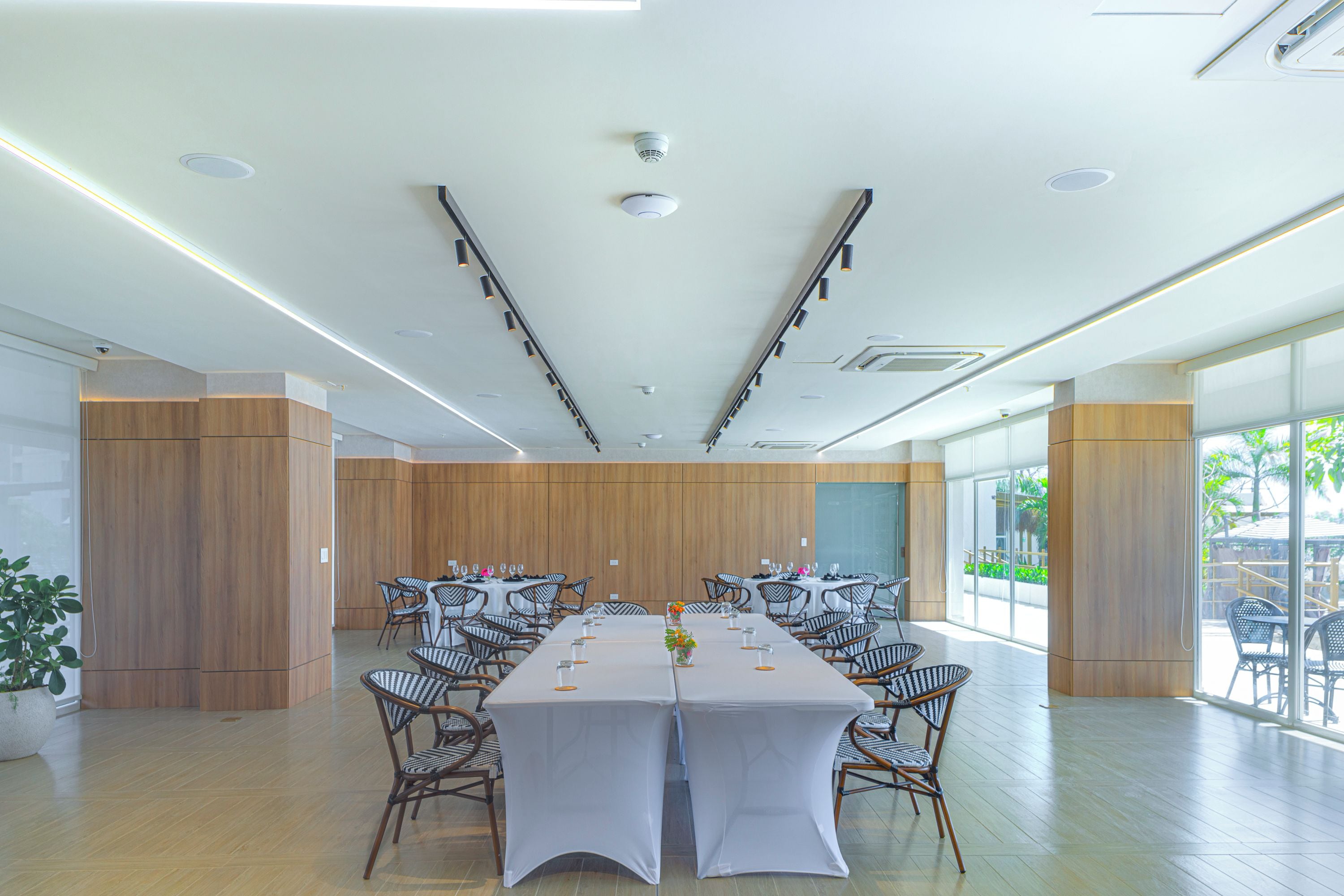 Une salle de conférence avec une longue table, des chaises et une grande fenêtre.