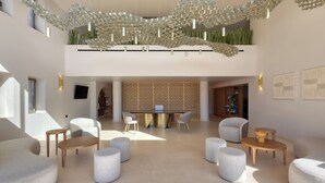 Un hall d’entrée spacieux, agrémenté d’un lustre moderne, de plusieurs coins salon et d’une table centrale.