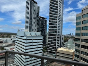 A high-rise building with a modern architectural design, featuring a prominent vertical structure and a flat roof. -  2 Bdrm Apart -90m2, 2mins walk station Free Carpark (Chatswood)