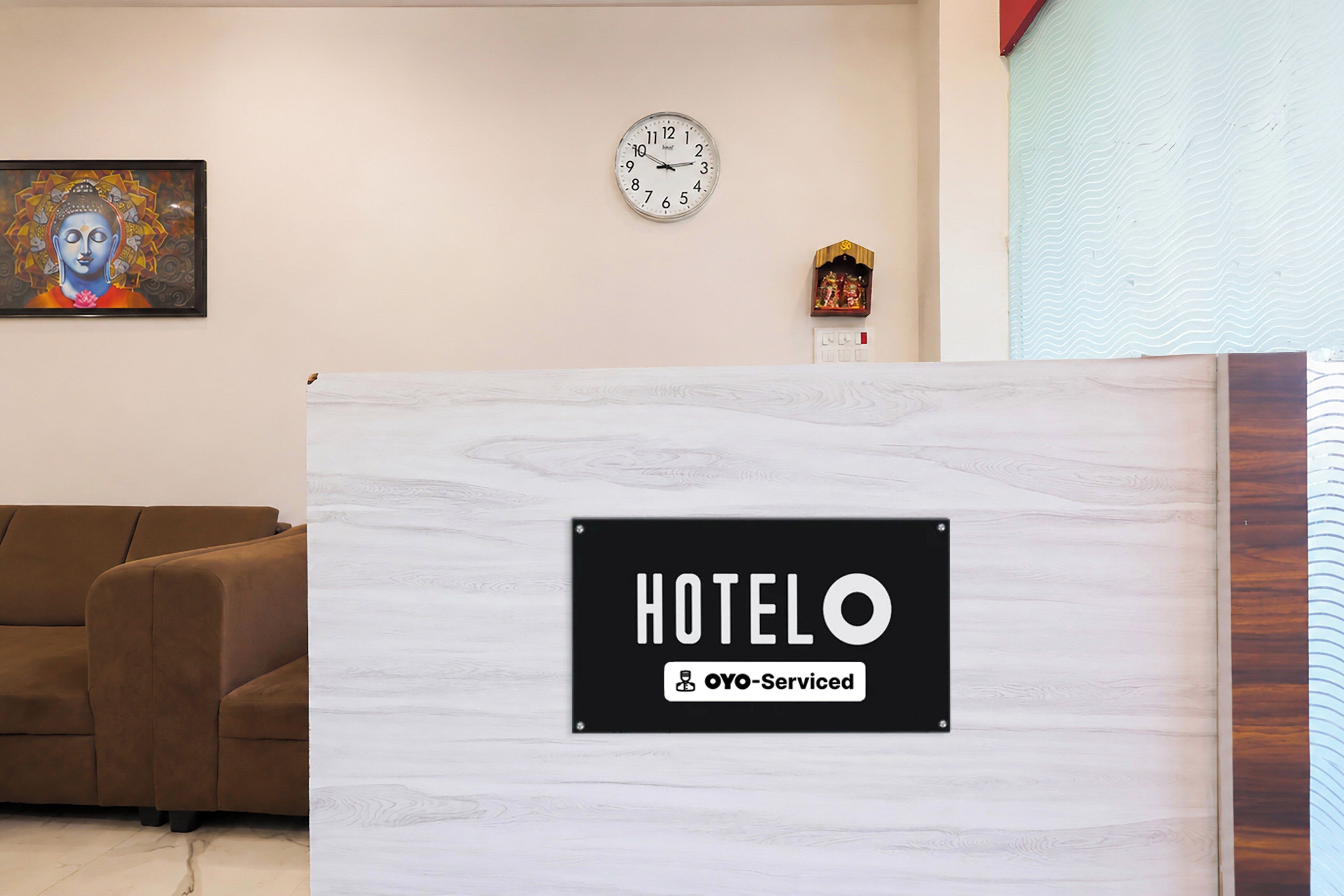 Ein Hotelrezeptionstresen mit einem Schild, das angibt, dass es sich um eine OYO-Betriebsstätte handelt.