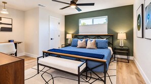 A bedroom with a bed, bedside tables, a desk, and a ceiling fan. - Richardson Retreat - Pool, Hot Tub & Fire Pit (Richardson)