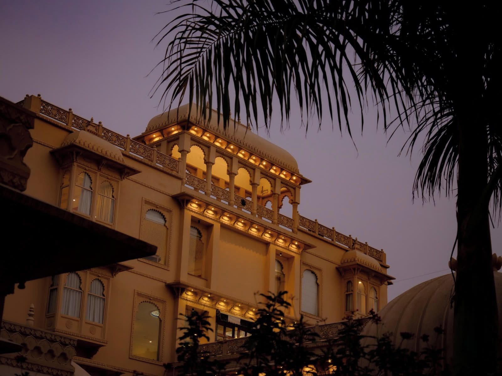 A traditional building with ornate architectural details, including arched windows and a balcony with railings.