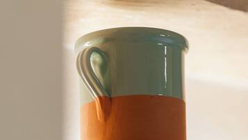 A glass mug on a shelf.