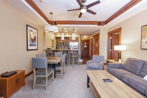 A hotel room with a dining area, a sofa, a coffee table, and a ceiling fan. - Peakside at One Ski Hill: Peak 8 Ski-In/Out, 2 Baths, A/C, Pools, Shuttle (Breckenridge)