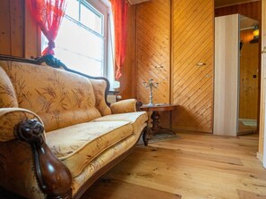 A wooden interior with a sofa and a table. - Holiday Home in Busum With Swimming Pool (Büsum)