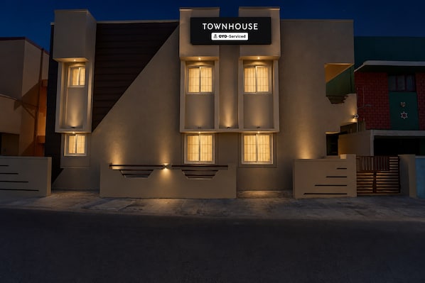 A townhouse with a modern design, featuring a prominent sign that reads 'TOWNHOUSE OYO-Serviced.'