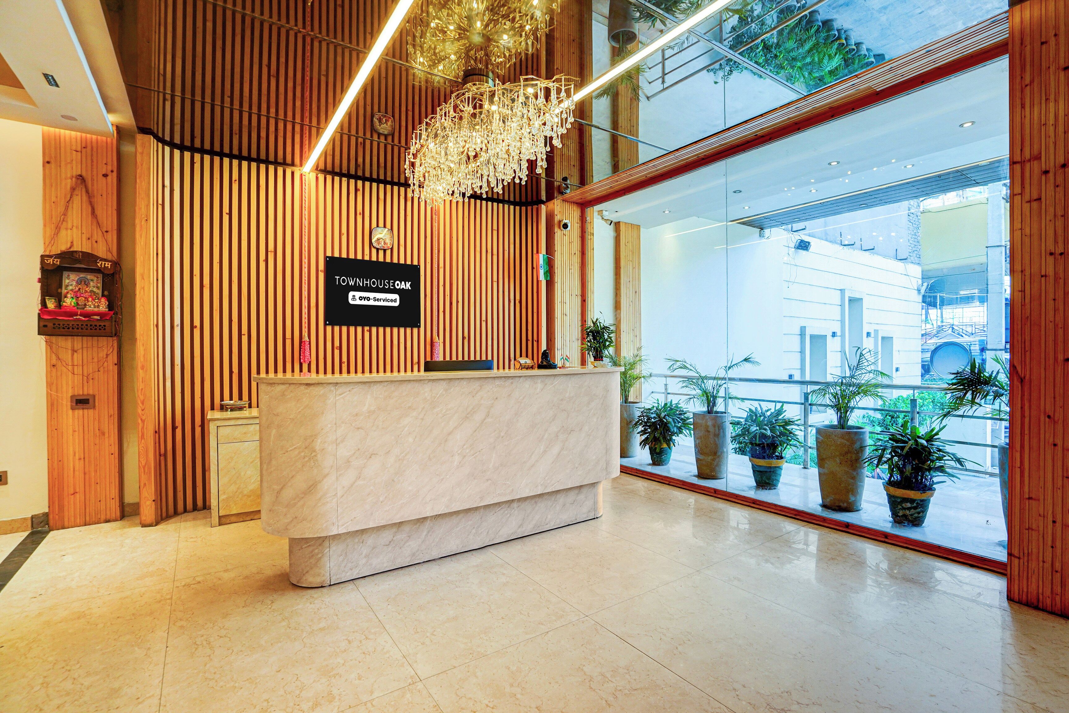 A reception desk with a sign indicating it is serviced by OYO.