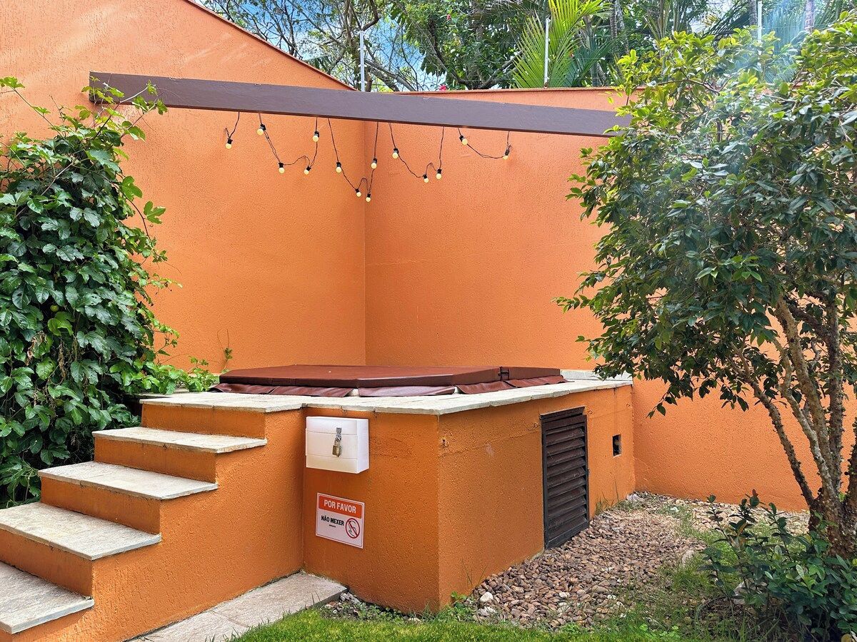 A spa area with a hot tub, steps leading up to it, and a sign indicating no smoking.
