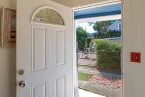 A white door with a glass panel and a small window above it. - 2 Mi to Dtwn Pensacola: Historic Home w/ Patio! (Pensacola)