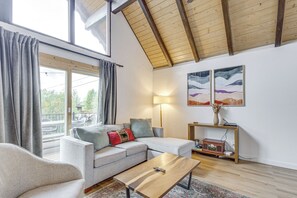 A modern living room with a sofa, coffee table, and artwork on the wall. - Mtn-view Cabin Escape in Heart of Grand Lake (Grand Lake)