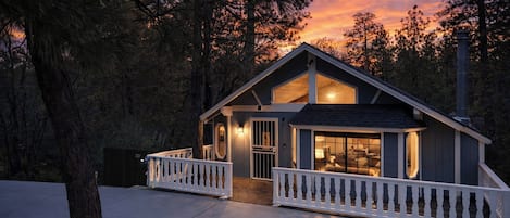 A two-story house with a balcony, a porch, and a garage.
