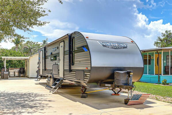A recreational vehicle with a kitchen area, a sleeping berth, and a bathroom. - River Ranch RV Retreat w/ Pool & Hot Tub Access (River Ranch)