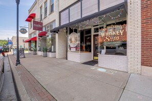 A storefront with a whiskey shop and a coffee shop.