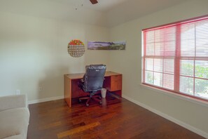 A room with a wooden desk, a chair, a window with blinds, and a wall-mounted picture. - Lewisville Lake Escape, 4 Mi to Boat Ramp (Little Elm)
