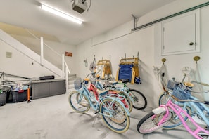 A multi-level indoor space with bicycles, a staircase, and various storage items. - Luxury Bayfront Home, Private Dock, Steps to Beach (Englewood)