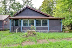A small, single-story building with a gabled roof and a covered porch area.