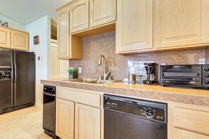 A modern kitchen with wooden cabinets, stainless steel appliances, and granite countertops. - Panoramic Views! Clear Lake Cottage w/ Patio (Clearlake)